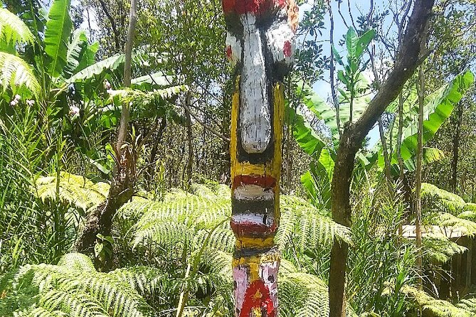 Hawaiian Tikis and Guava Tea - Chess-themed tiki statues along a pallet fence